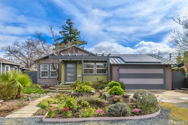 view of front of property with a garage and solar panels