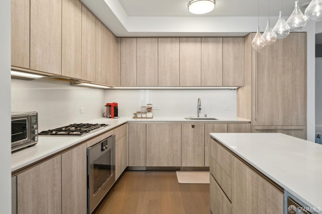 333 Beale St Unit 4E, San Francisco, CA 94105 - kitchen featuring light brown cabinetry, a sink, modern cabinets, and stainless steel gas cooktop