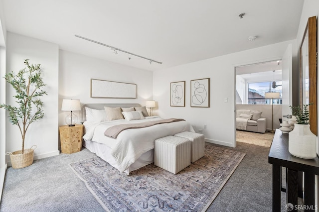 bedroom featuring carpet floors and track lighting