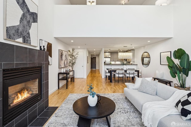 living room featuring hardwood / wood-style floors and a tiled fireplace