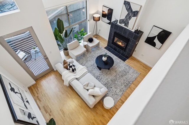 living room with hardwood / wood-style flooring, a fireplace, and plenty of natural light