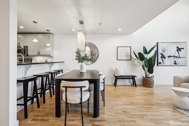 dining area with light hardwood / wood-style floors