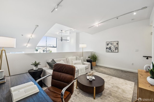 living room with ceiling fan, rail lighting, and carpet flooring