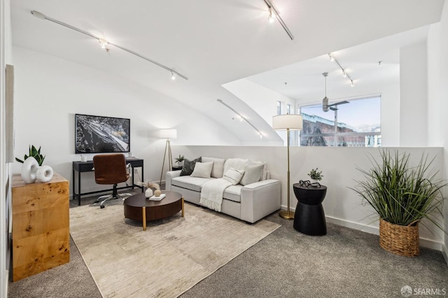 carpeted living room featuring lofted ceiling and track lighting