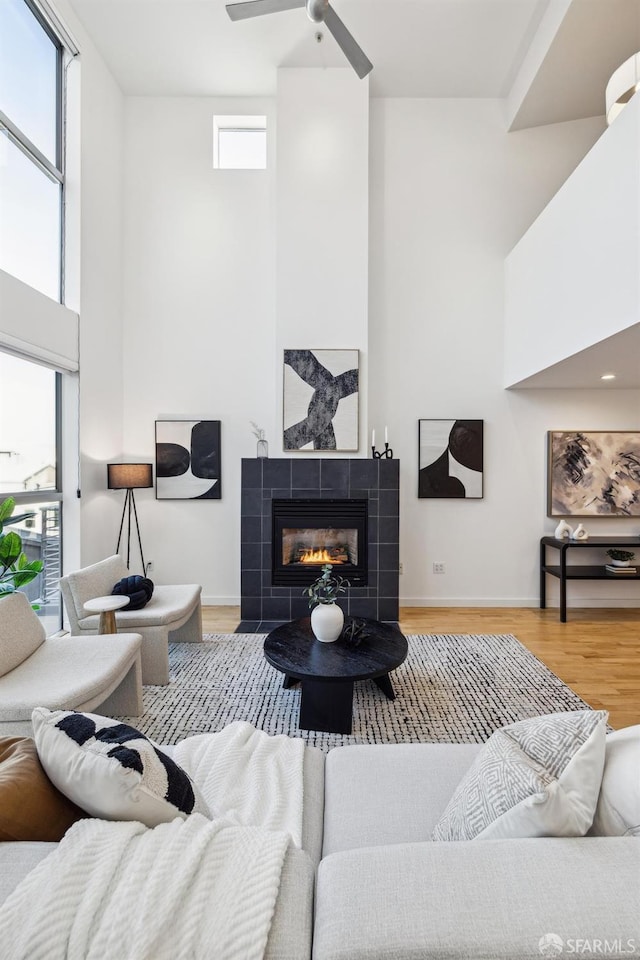 living room with a healthy amount of sunlight, a fireplace, and hardwood / wood-style floors