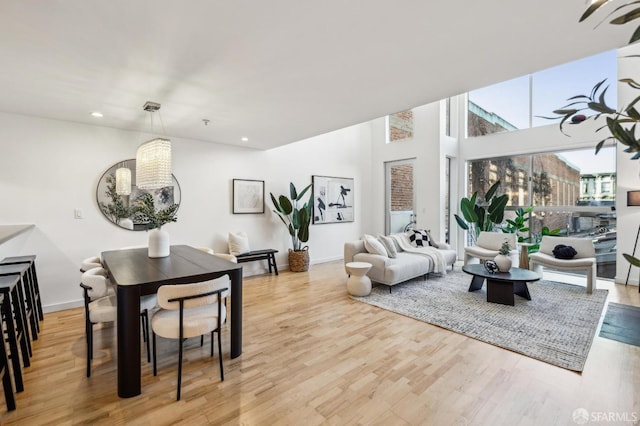 living room featuring an inviting chandelier and light hardwood / wood-style floors