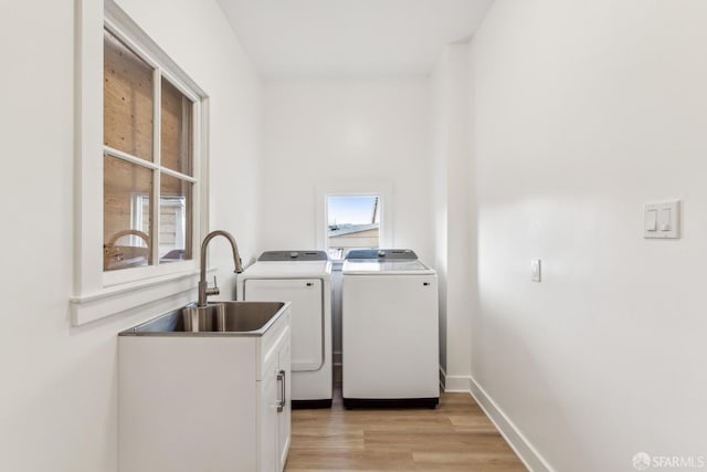 1015 Key Ave, San Francisco, CA 94124 - laundry room with cabinet space, washing machine and dryer, and light wood finished floors
