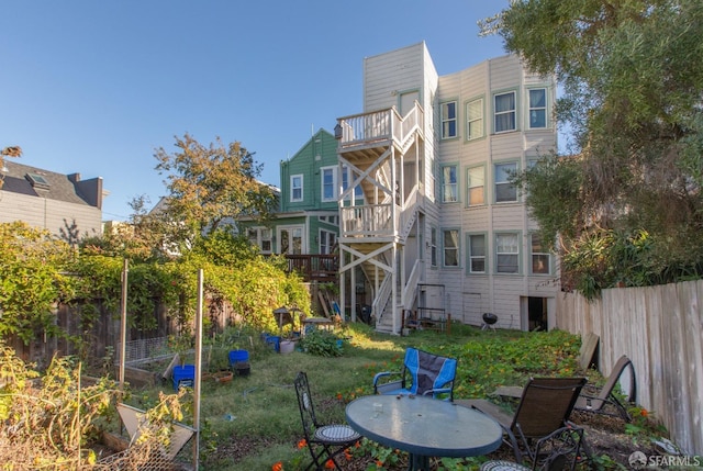 back of property featuring a yard and a balcony