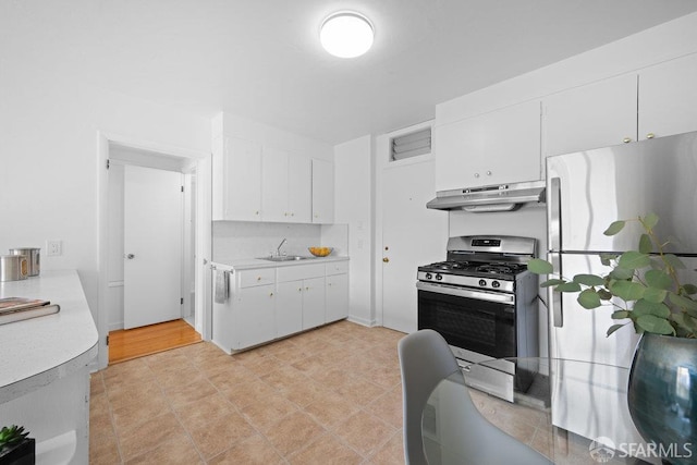 57 Masonic Ave, San Francisco, CA 94118 - kitchen featuring appliances with stainless steel finishes, under cabinet range hood, light countertops, and white cabinetry