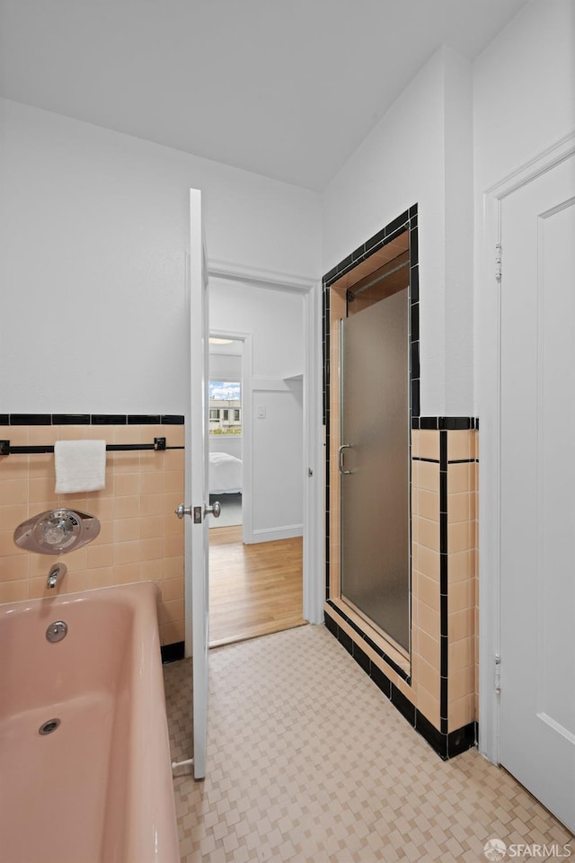 57 Masonic Ave, San Francisco, CA 94118 - bathroom with a bath, tile walls, tile patterned floors, and a wainscoted wall