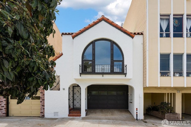 57 Masonic Ave, San Francisco, CA 94118 - view of front facade featuring stucco siding, a garage, a balcony, and a tiled roof