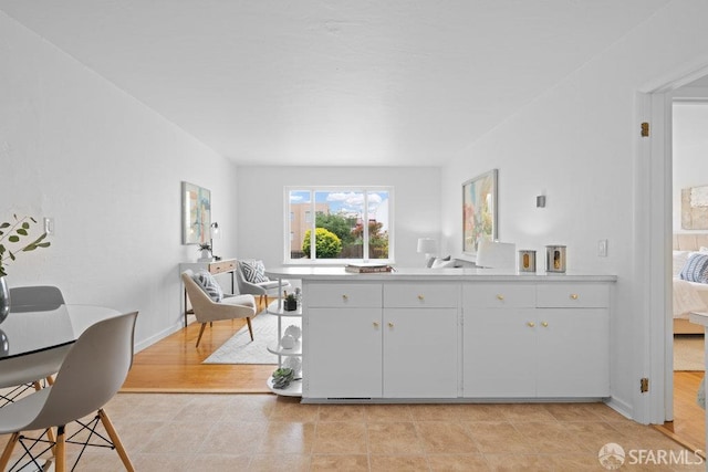 57 Masonic Ave, San Francisco, CA 94118 - kitchen featuring light countertops, a desk, white cabinets, and light tile patterned floors