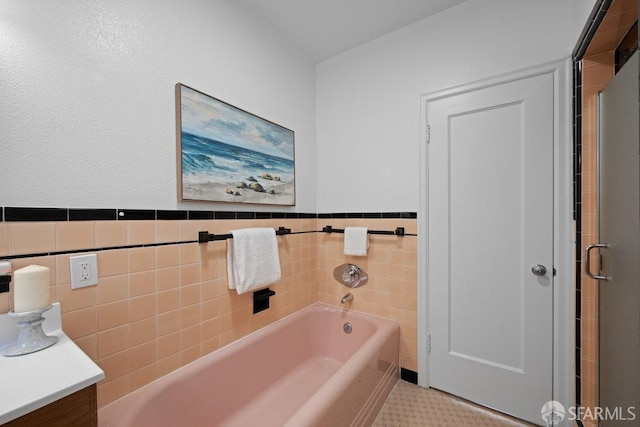 57 Masonic Ave, San Francisco, CA 94118 - bathroom with a garden tub, tile walls, vanity, wainscoting, and a stall shower