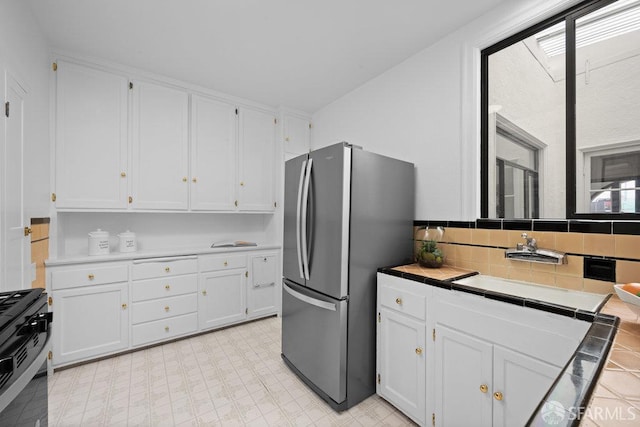 57 Masonic Ave, San Francisco, CA 94118 - kitchen with freestanding refrigerator, tile countertops, gas range, and white cabinets