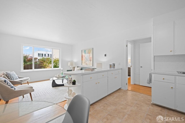 57 Masonic Ave, San Francisco, CA 94118 - kitchen featuring light countertops, open shelves, white cabinets, and a peninsula