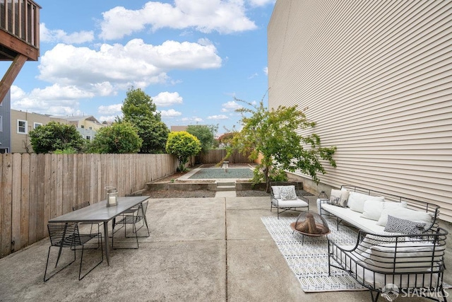 57 Masonic Ave, San Francisco, CA 94118 - fenced backyard with an outdoor living space with a fire pit, a patio area, and outdoor dining space