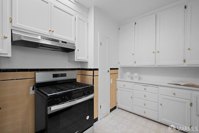 57 Masonic Ave, San Francisco, CA 94118 - kitchen with gas range, under cabinet range hood, tile walls, white cabinetry, and a wainscoted wall