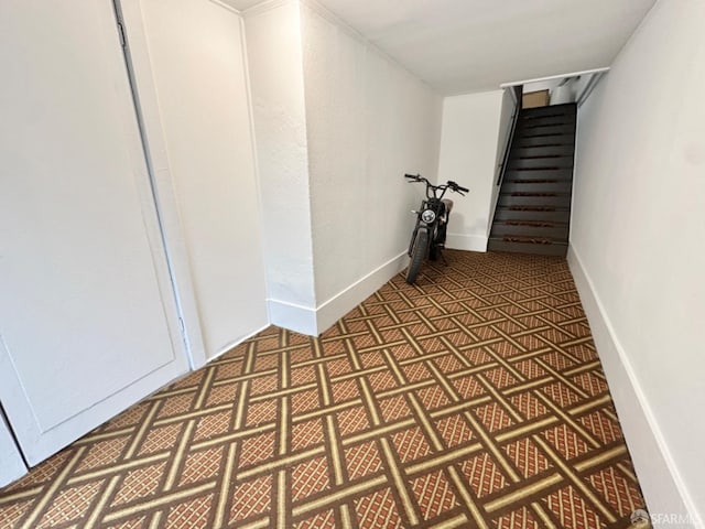 hallway with stairway and baseboards