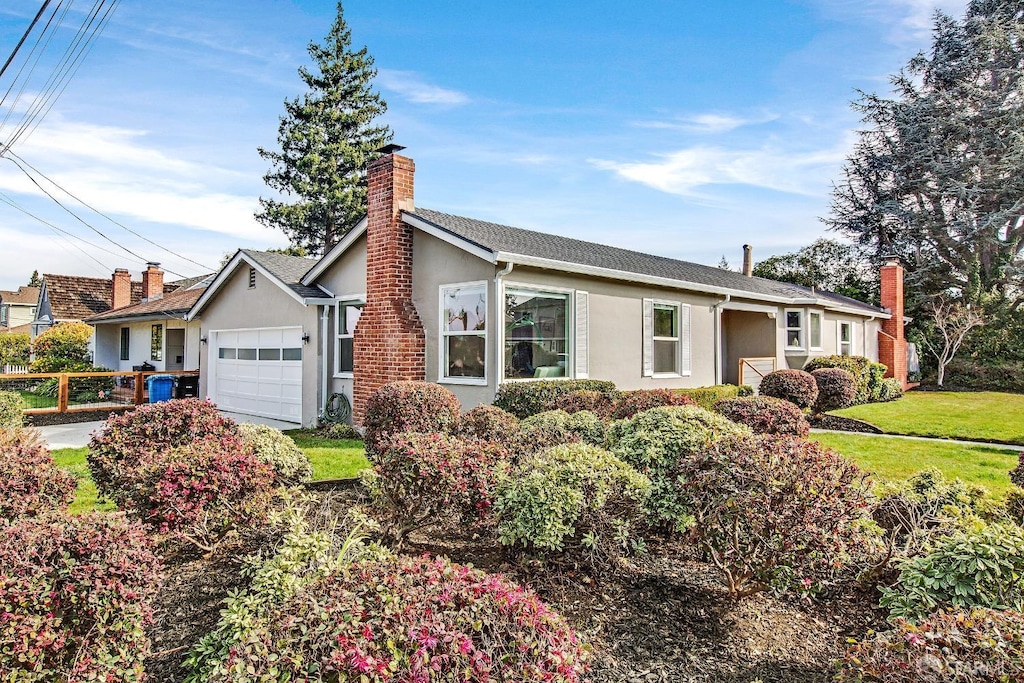 ranch-style home featuring a garage and a front yard