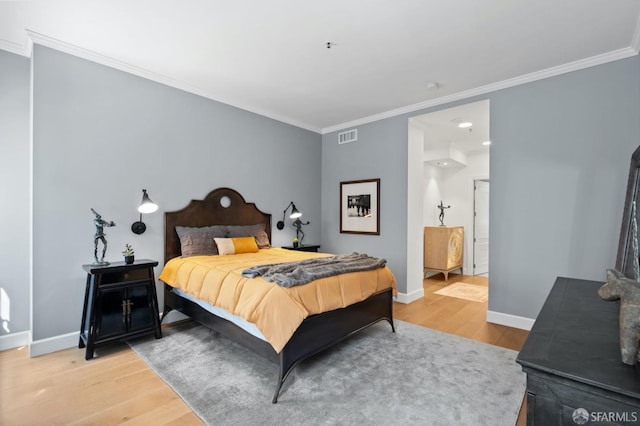 bedroom with crown molding, baseboards, visible vents, and light wood-style floors