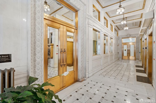 corridor featuring an inviting chandelier and crown molding