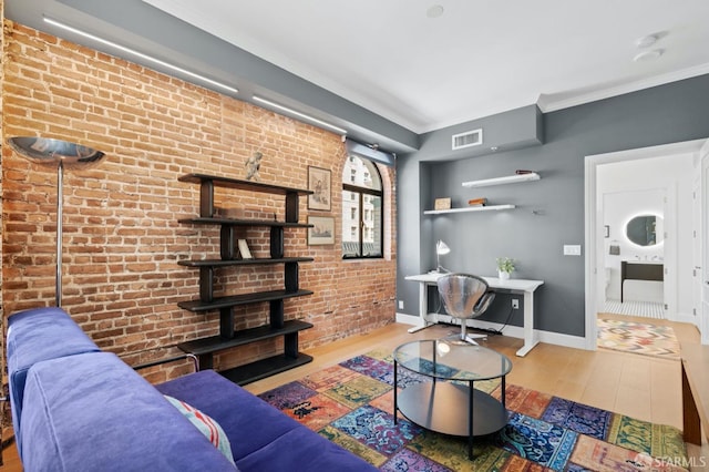 living area with visible vents, wood finished floors, baseboards, and ornamental molding