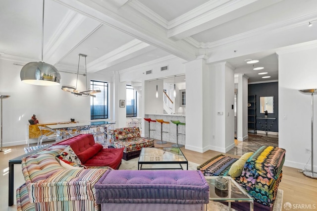 living area featuring wood finished floors, beam ceiling, visible vents, baseboards, and ornamental molding