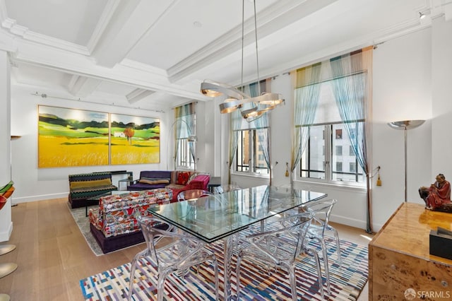 dining area with beam ceiling, crown molding, a notable chandelier, coffered ceiling, and baseboards
