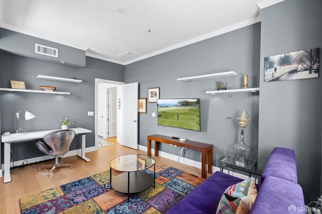 living room with ornamental molding, baseboards, visible vents, and wood finished floors