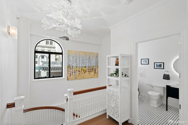 bathroom featuring vanity, toilet, crown molding, and a notable chandelier