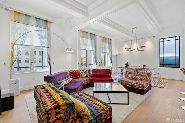 living area with baseboards, ornamental molding, hardwood / wood-style floors, and beam ceiling