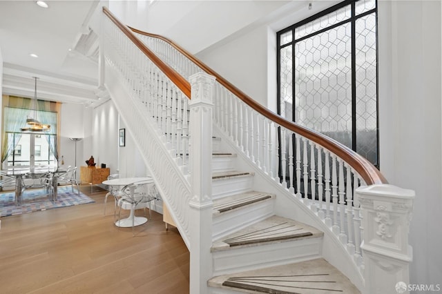 staircase with recessed lighting and wood finished floors