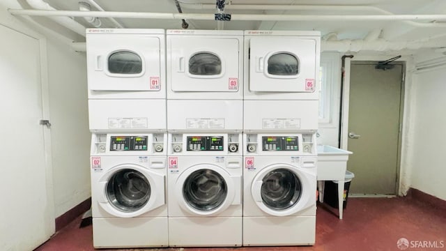 laundry area featuring stacked washer and dryer and washing machine and clothes dryer