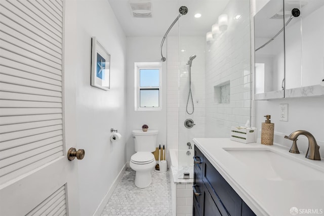 full bathroom featuring tile patterned flooring, vanity, toilet, and tiled shower / bath