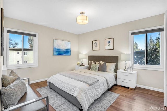 bedroom with hardwood / wood-style flooring