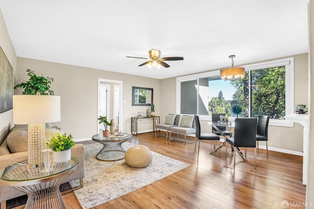 living room with hardwood / wood-style floors, ceiling fan, and a wealth of natural light