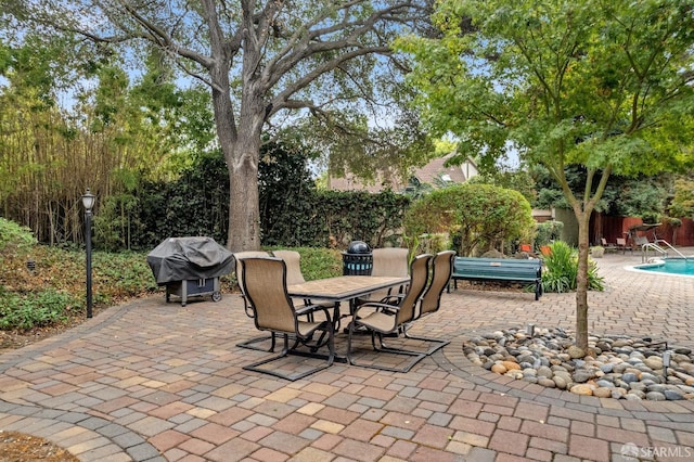 view of patio with a fenced in pool and grilling area