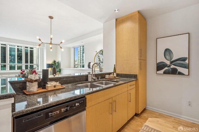 kitchen with light brown cabinets, sink, an inviting chandelier, stainless steel dishwasher, and light wood-type flooring