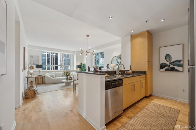 kitchen featuring kitchen peninsula, dishwasher, light brown cabinetry, and light hardwood / wood-style flooring