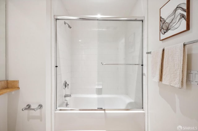 bathroom with shower / bath combination with glass door