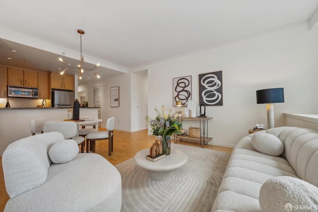 living room with light hardwood / wood-style flooring and a notable chandelier