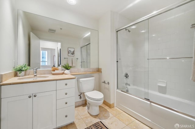 full bathroom with tile patterned floors, vanity, toilet, and enclosed tub / shower combo