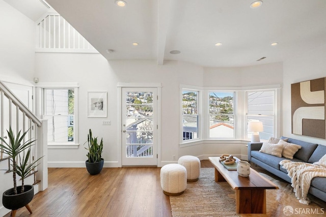 living area featuring recessed lighting, plenty of natural light, baseboards, and wood finished floors