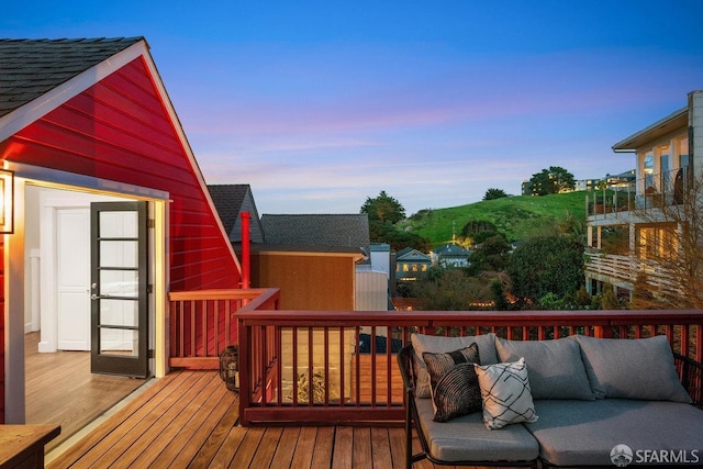 deck at dusk with an outdoor living space