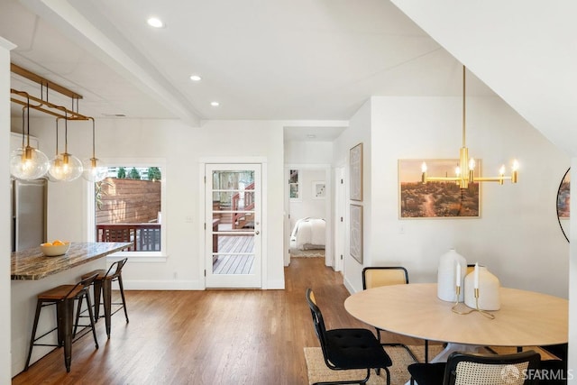 dining room with beam ceiling, a notable chandelier, recessed lighting, wood finished floors, and baseboards