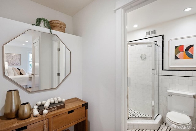 full bathroom featuring toilet, a shower stall, visible vents, and recessed lighting