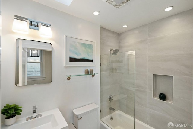 bathroom featuring toilet, recessed lighting, a sink, visible vents, and washtub / shower combination