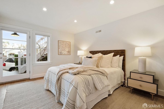 bedroom featuring recessed lighting, visible vents, wood finished floors, access to outside, and baseboards