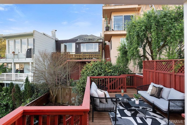 wooden terrace with an outdoor hangout area