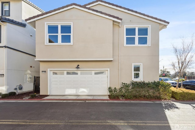 2768 Bette St, Alameda, CA 94501 - view of front of house featuring stucco siding, a tiled roof, and an attached garage